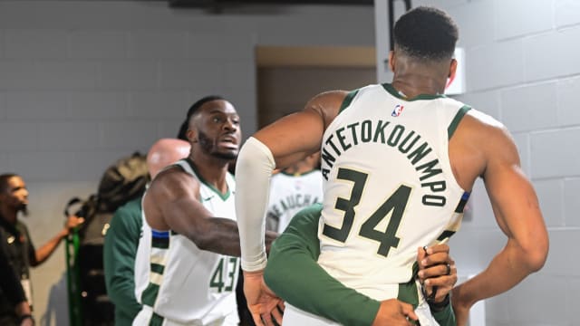 Milwaukee Bucks forward Giannis Antetokounmpo (34) is restrained by a coach outside the Indiana Pacers locker room